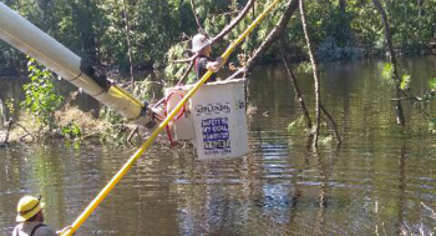 Lineworkers near the town of Coward face water challenges as they work to restore power.